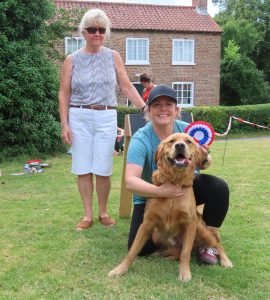 Supreme Champion Rex with handler Caroline and judge Celia