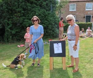 Waggiest Tail winner Otis with handler Maryam and judge Celia
